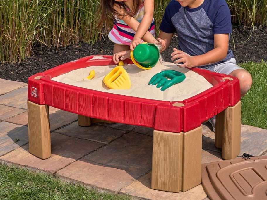 kids playing with Step2 Naturally Playful Sand Table