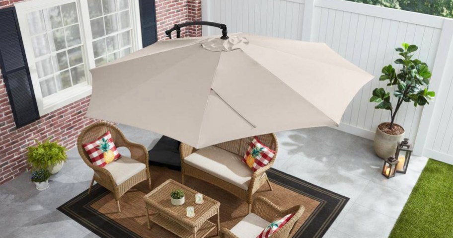 large umbrella hanging over patio furniture set