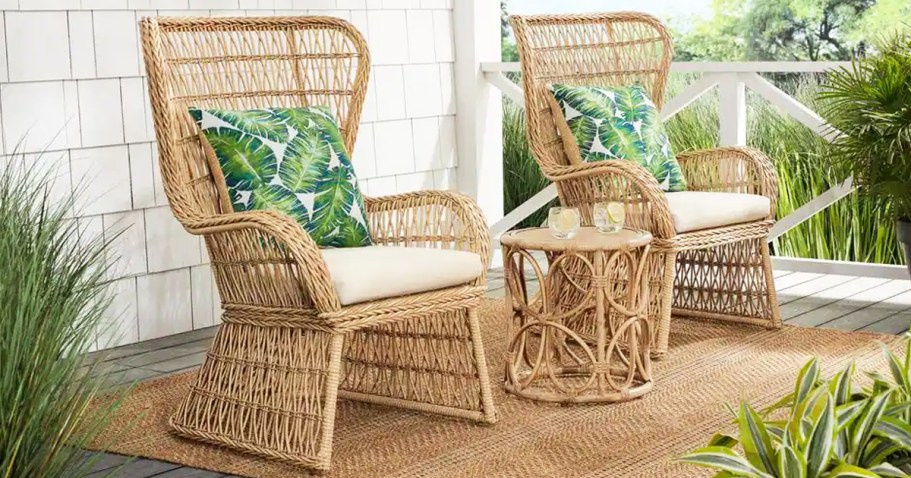 set of wicker chairs with beige cushions and matching side table