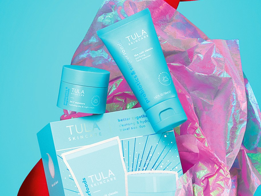 two blue TULA Skincare bottle with gift box and pink tissue paper