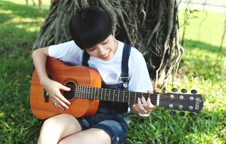 A girl playing a guitar