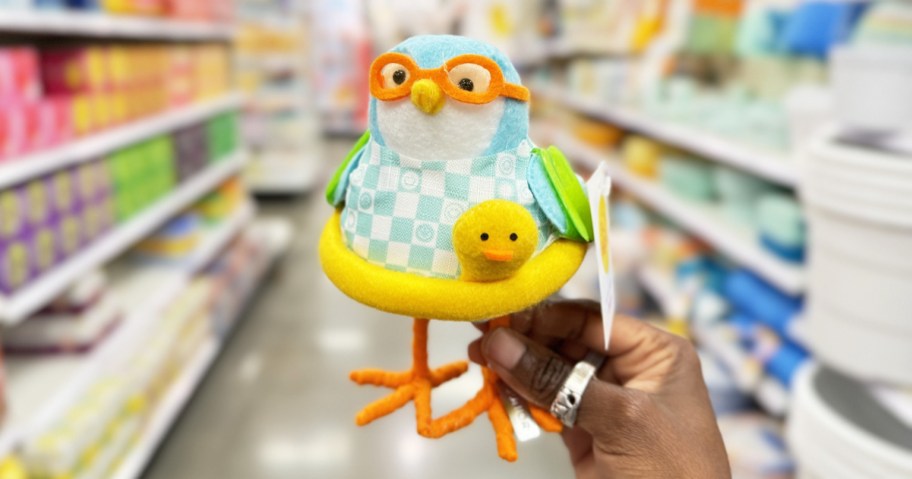hand holding up a felt bird dressed in swimwear and floaty