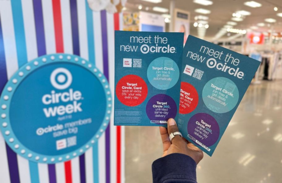 a womans hand holding target circle week ads