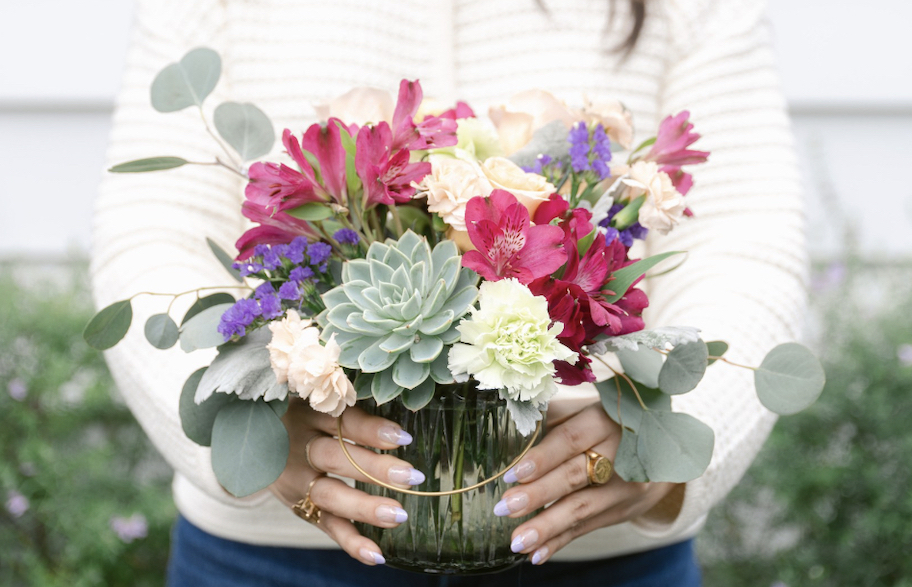 hands holding bouquet of flowers