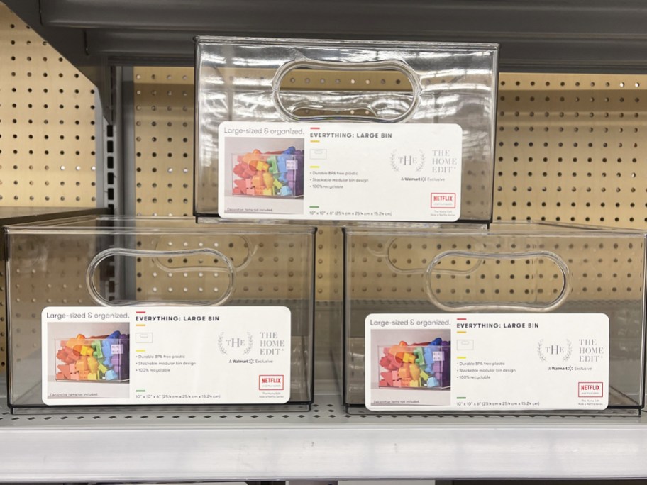 three stacked plastic storage bins on store shelf