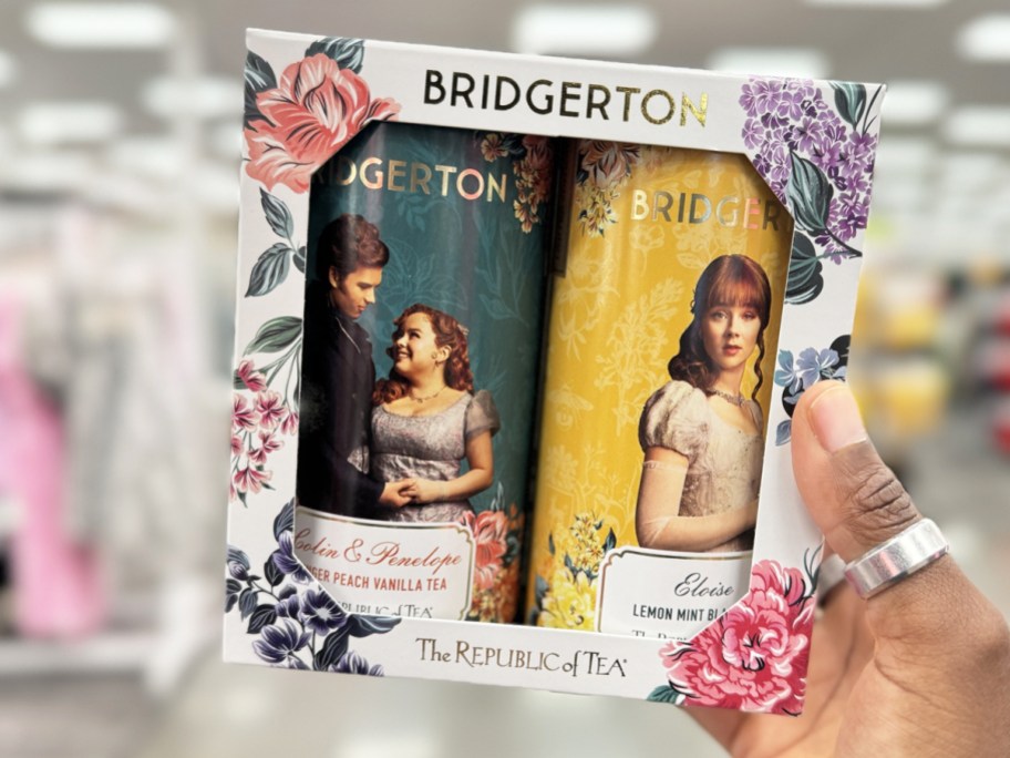 hand holding up a Bridgerton themed tea gift box set