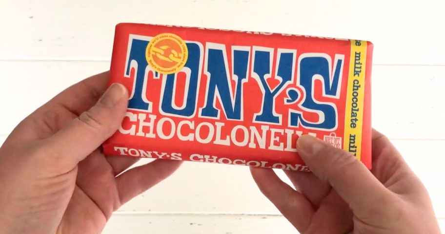 A person holding a Tony's Chocolonely Candy Bar