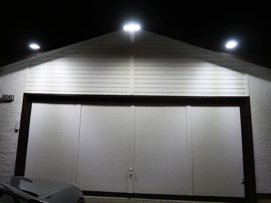 three solar lights on front of garage