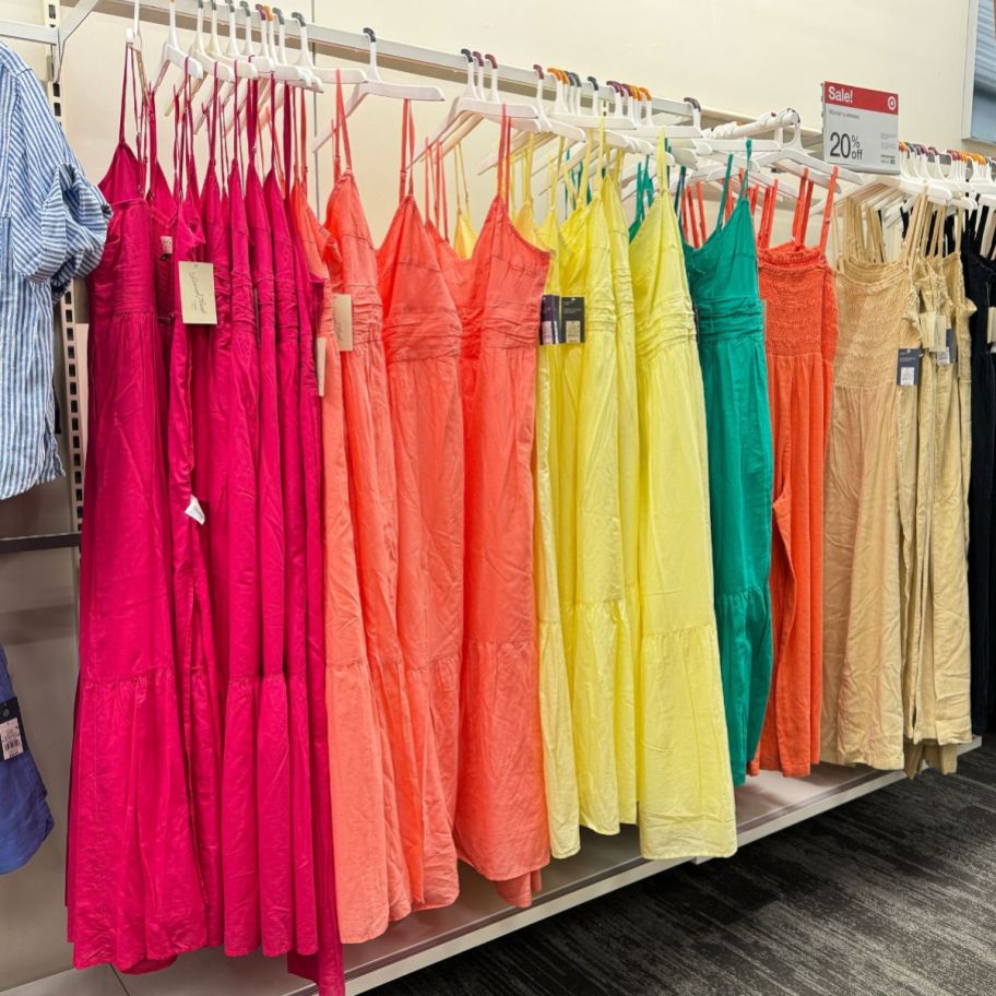 maxi sun dresses hanging on a wall in a store