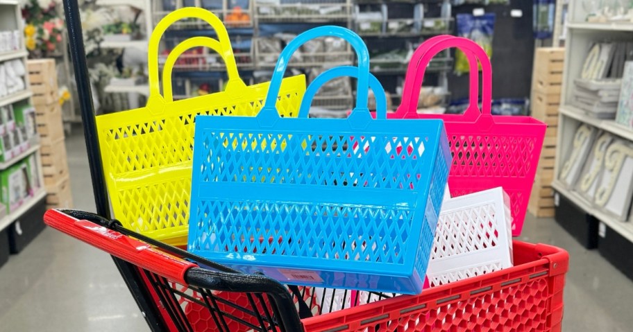 4 bright colored jelly style tote bags in a Michael's shopping cart