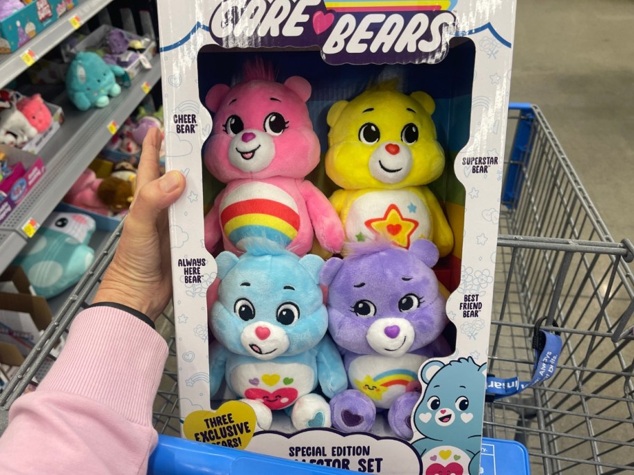 hand holding a Care Bears Collector Set with 4 Care Bears