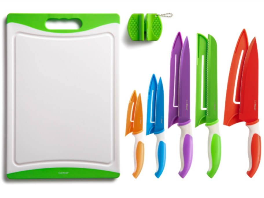 cutting board with colorful knives and knife sharpener on a counter
