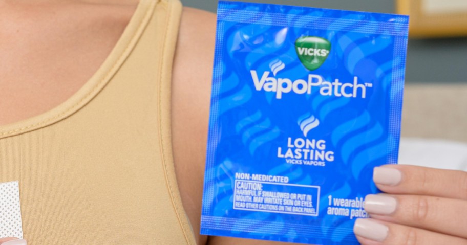 woman holding up a blue package for Vicks VapoPatch