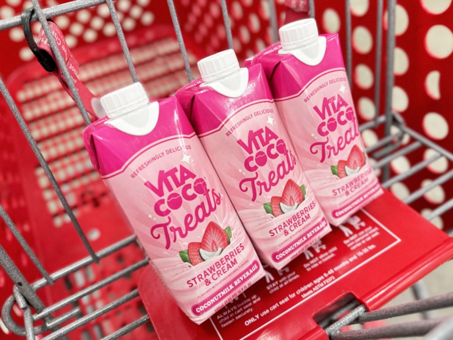 three pink cartons of Vita Coco Strawberries & Cream Treats Coconutmilk in red shopping cart