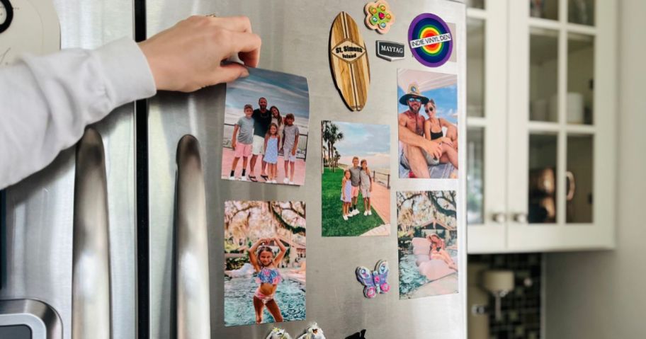 A woman placing a Walgreens 5X7 Picture Magnet on her fridge
