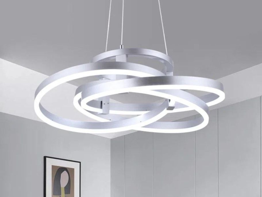 A ceiling with a Wade Logan Alliber Dimmable LED Geometric Chandelier on it