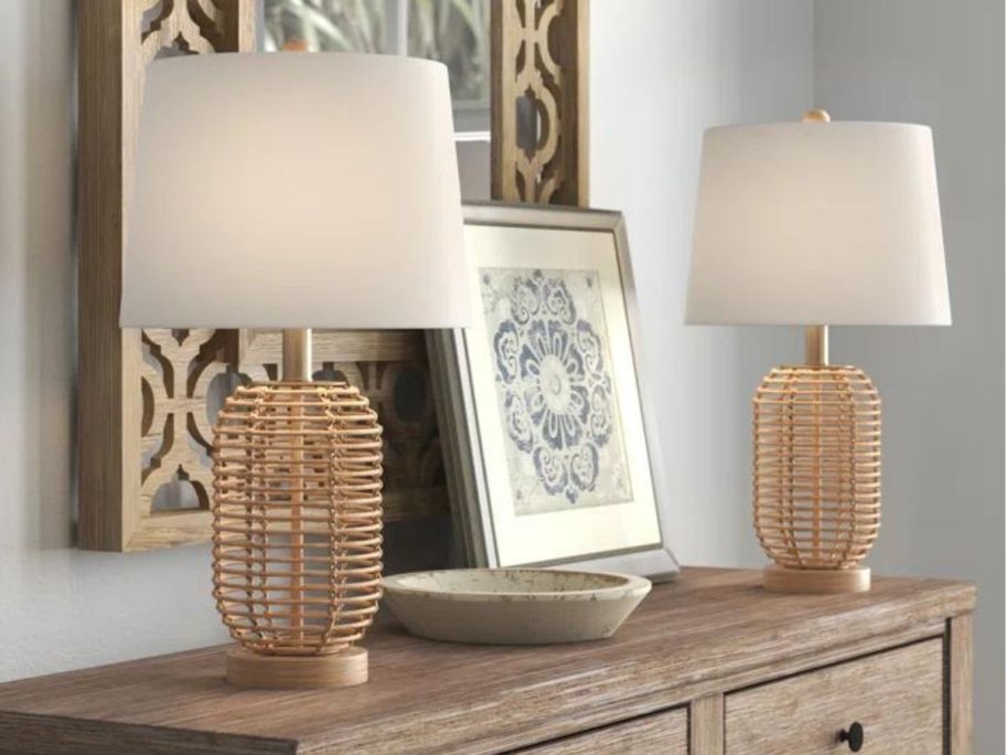 A dresser with two Mistana Arcola Wicker/Rattan Table Lamps on it