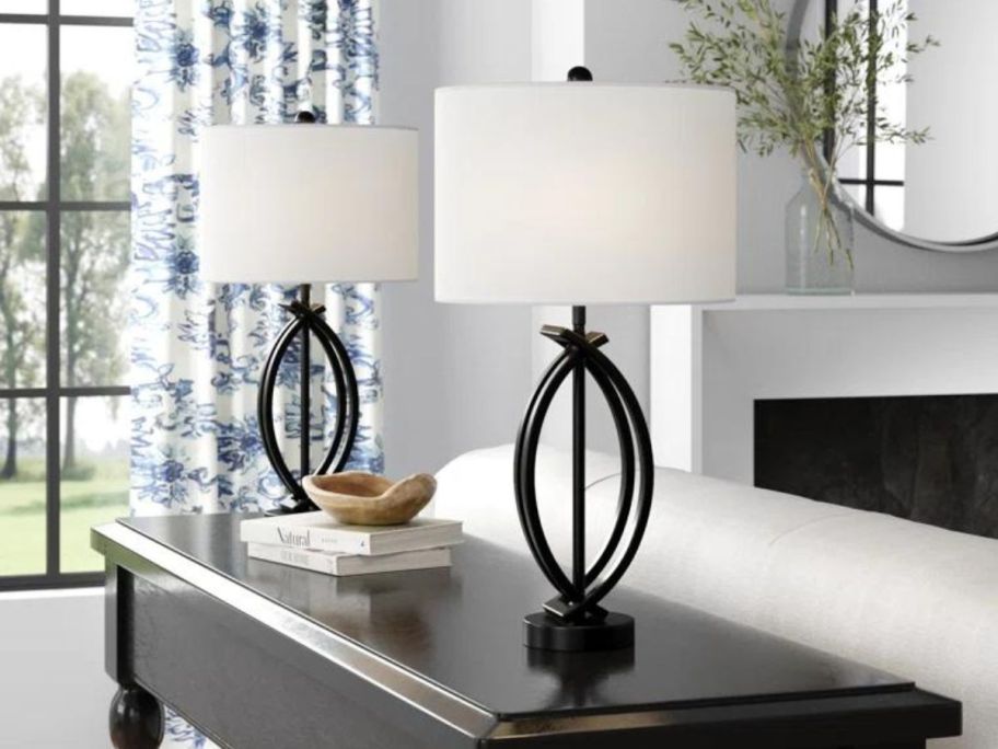 A console table with two Three Posts Burholme Metal Table Lamps on it