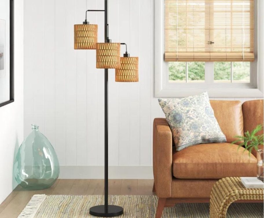 Sand & Stable Coleford 65'' Black Tree Floor Lamp next to a couch