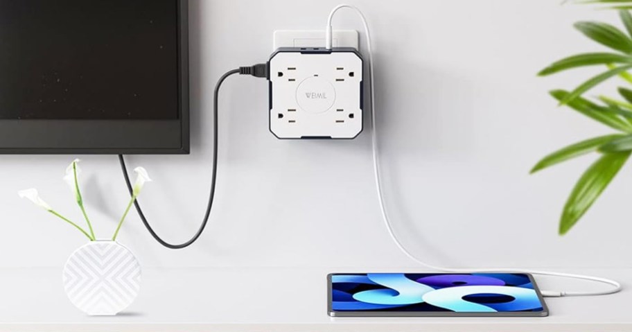 Weimil Wall Outlet Extender plugged into tv and tablet