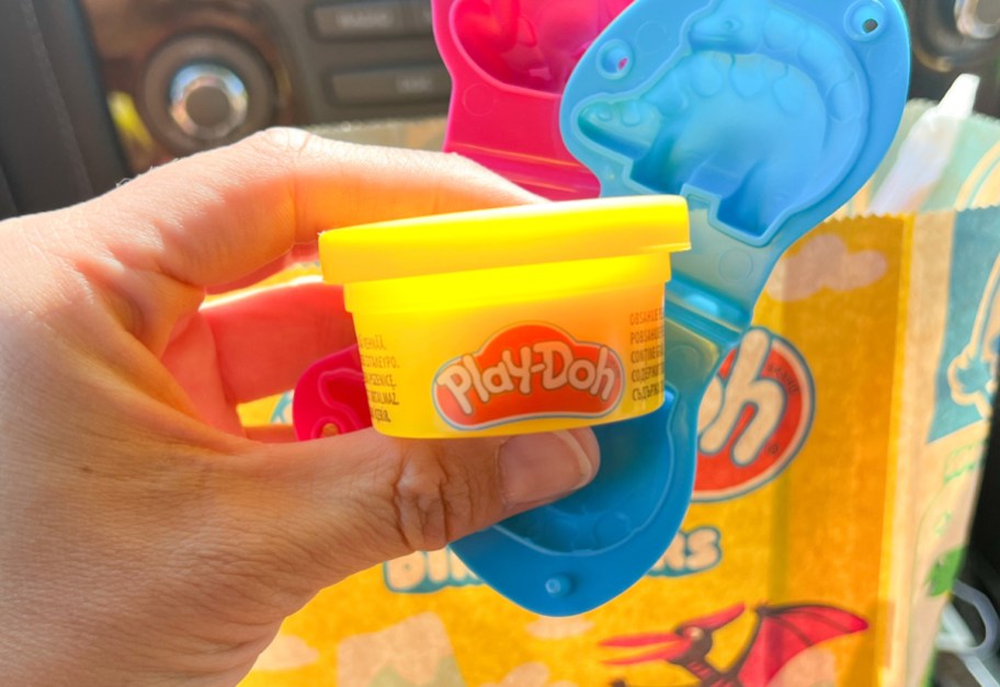 Hand holding a jar of Play-Doh that came as the Wendy's Kids Meal toy