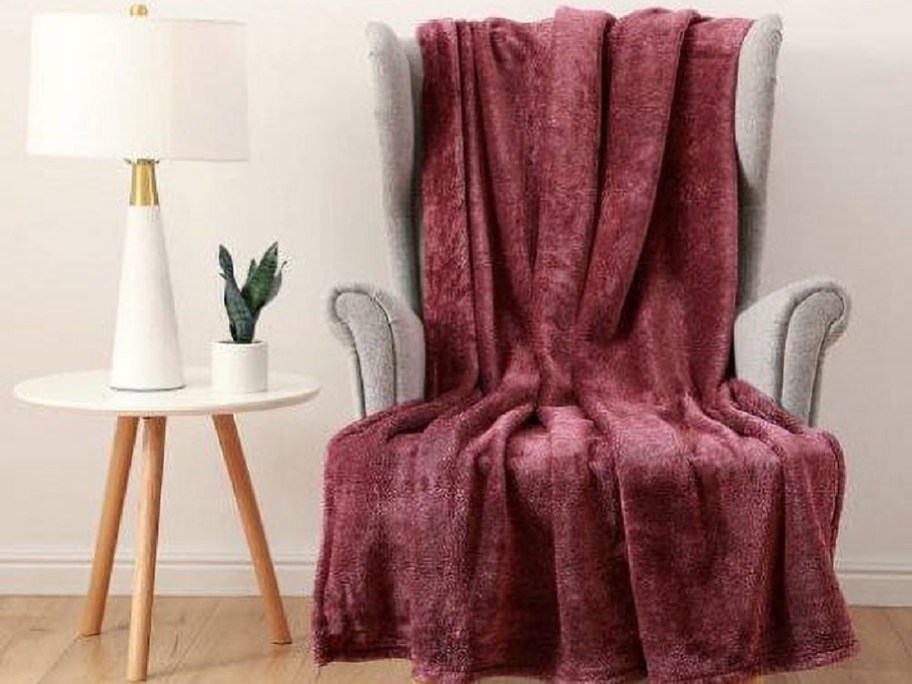 Wine color throw blanket displayed on the chair