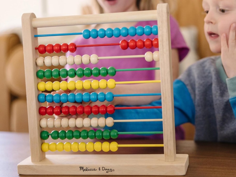Wood beads play set displayed with kids playing with it