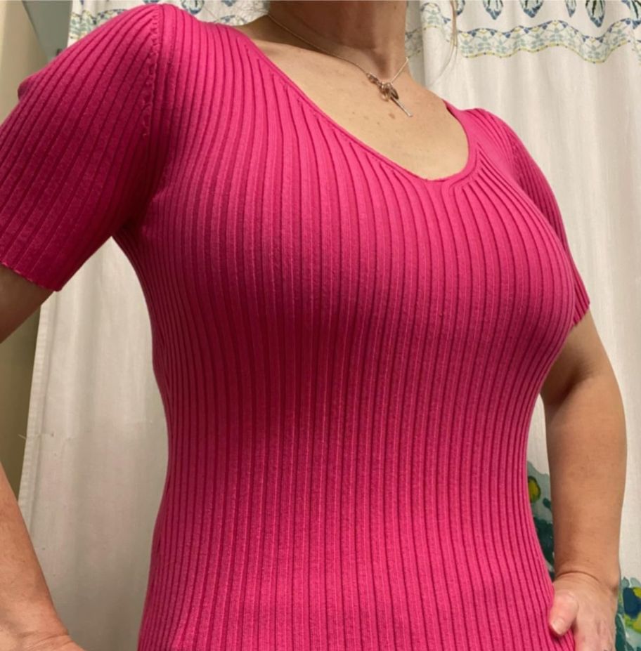 a woman wearing a hot pink vneck t-shirt