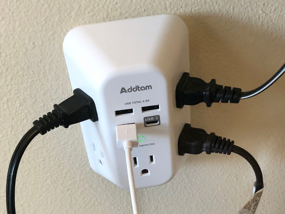 white outlet extender with cords plugged in