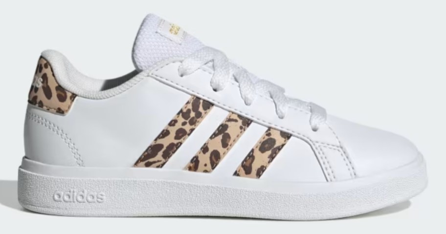 white adidas court style kid's shoe with leopard print accents