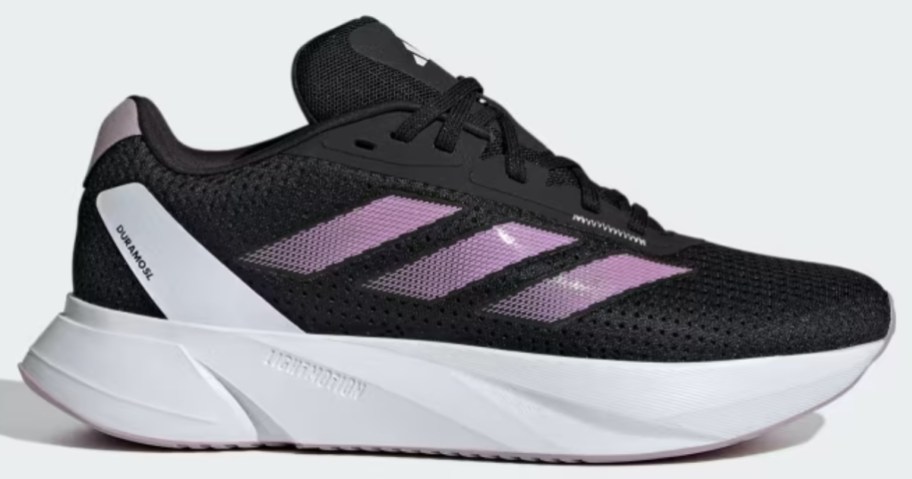black and white women's adidas running shoe with purple stripes
