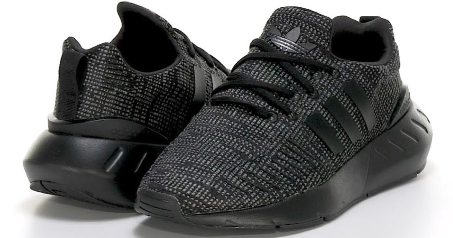 stock image of pair of black adidas shoes
