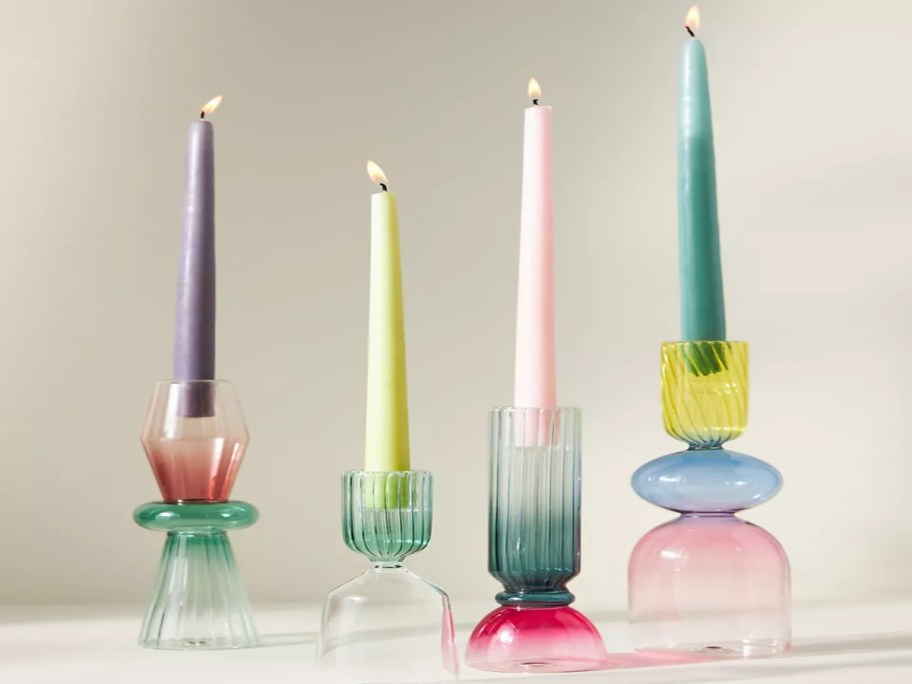 multicolored glass candle holders and candles
