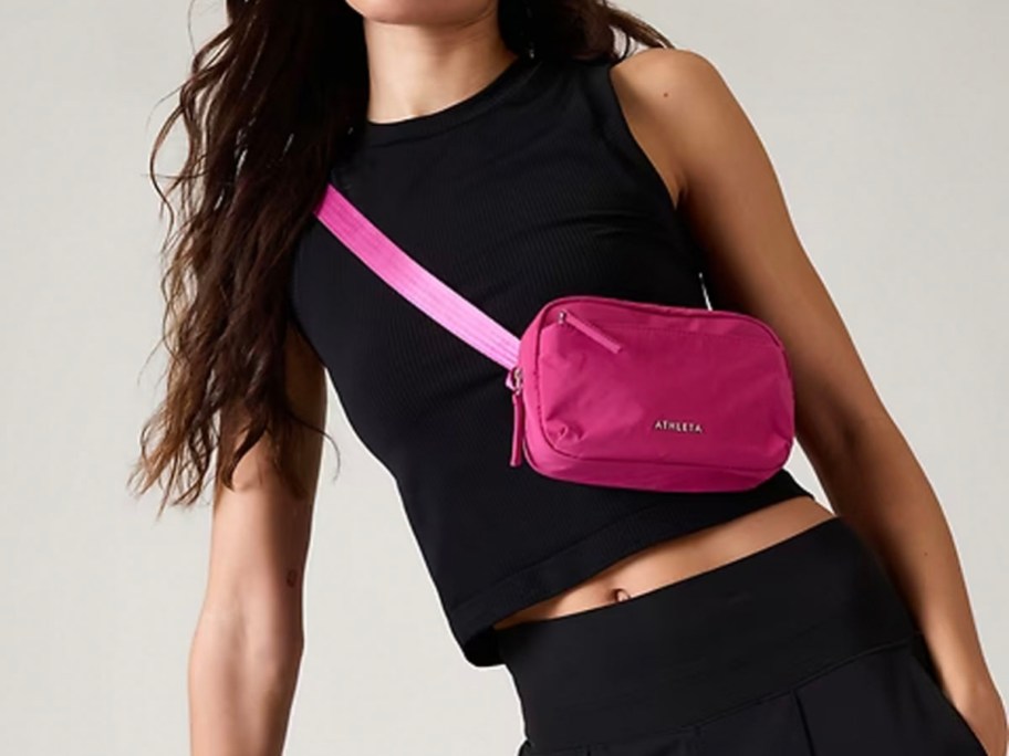 woman wearing hot pink belt bag