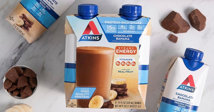 atkins chocolate banana protein drink 4 pack next to shakes on table