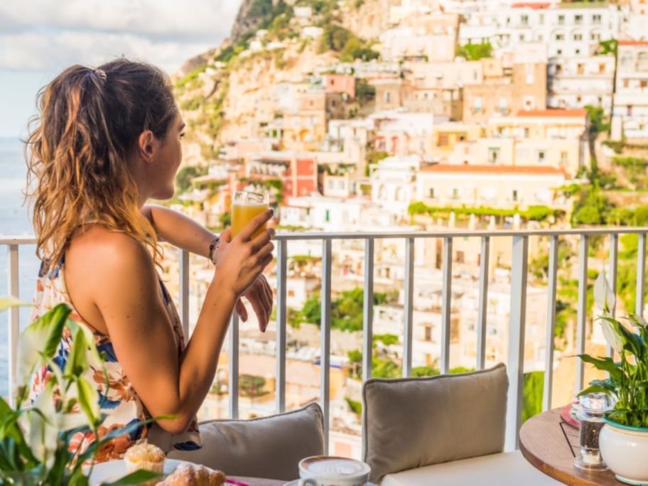 woman looking at the view from a balcony