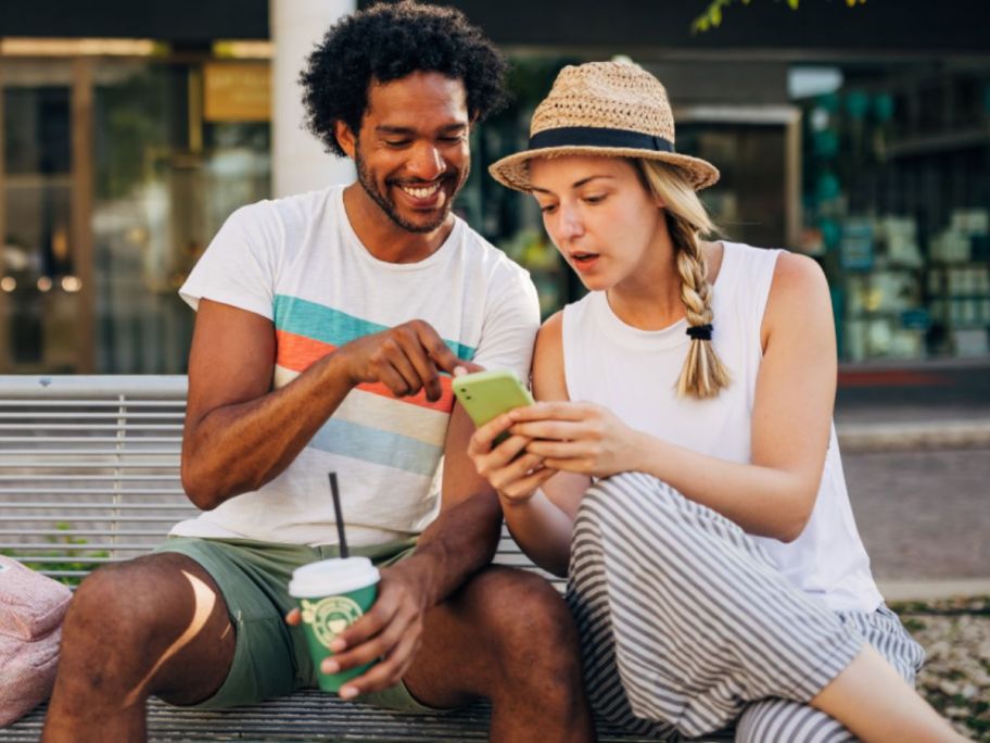 Woman and man looking at a phone