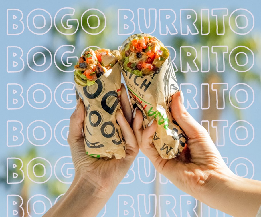 two hands holding burritos together