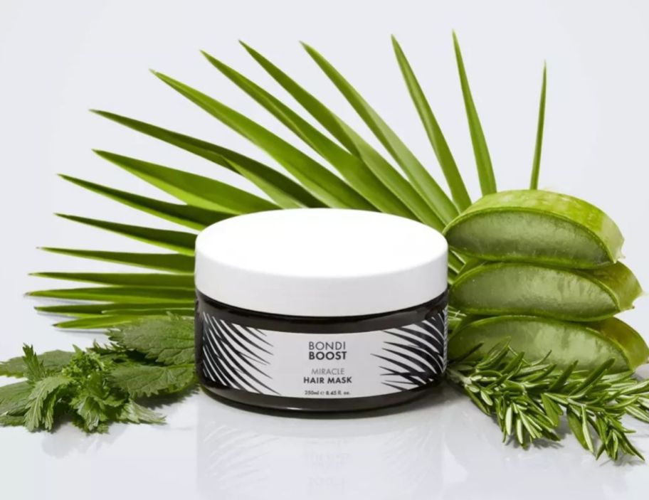 a jr of bondiboost miracle mask surrounded by green botanical plant ingerdients
