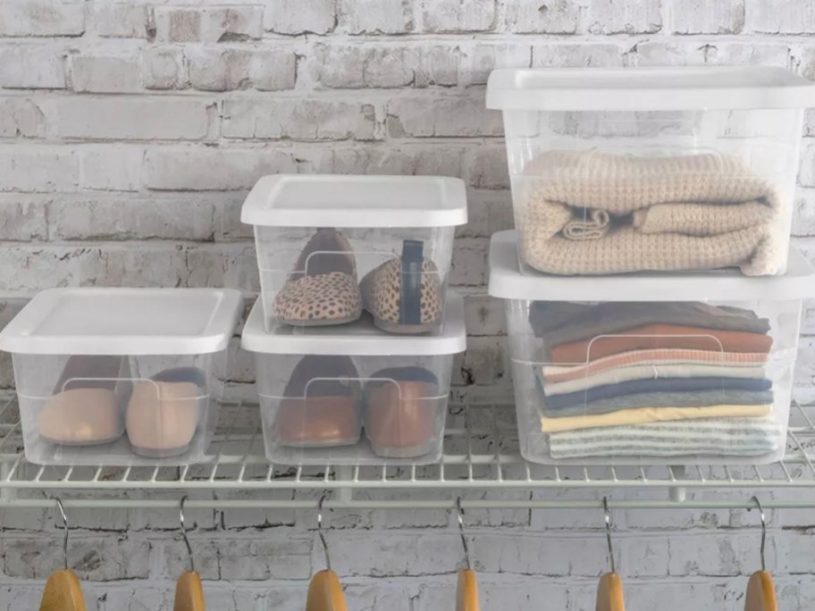 5 clear storage boxes with shoes and clothes inside