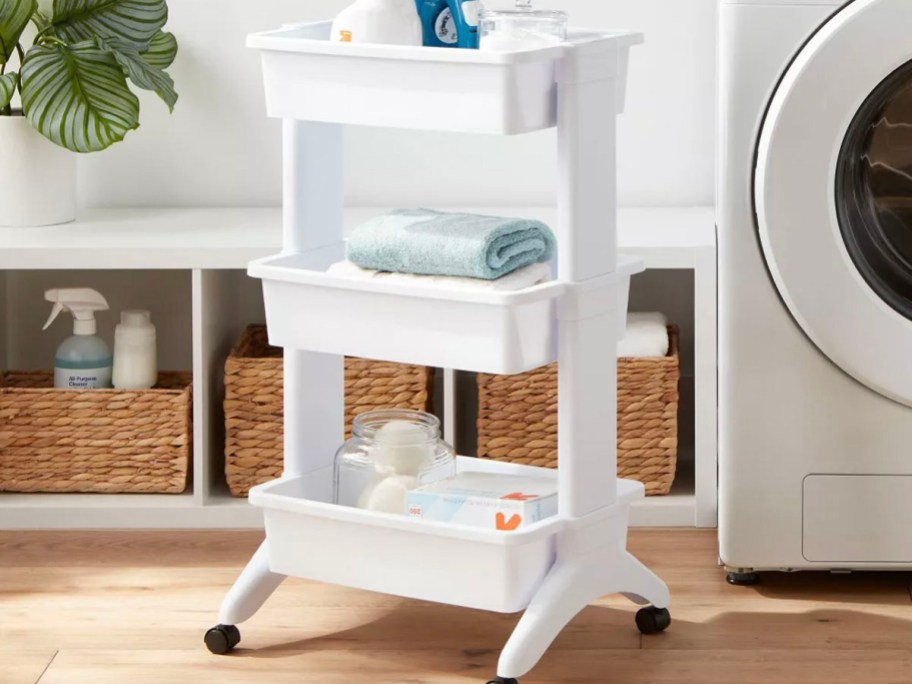 white 3 utility cart with bathroom products in room