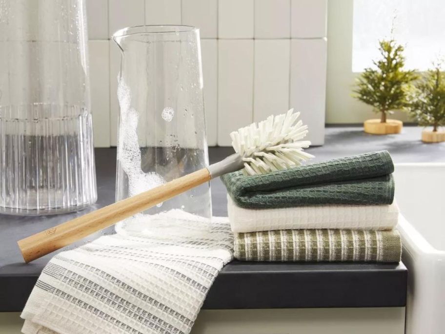 Hearth & Hand w/ Magnolia Nylon Bottle Brush on stack of towels in kitchen next to sink