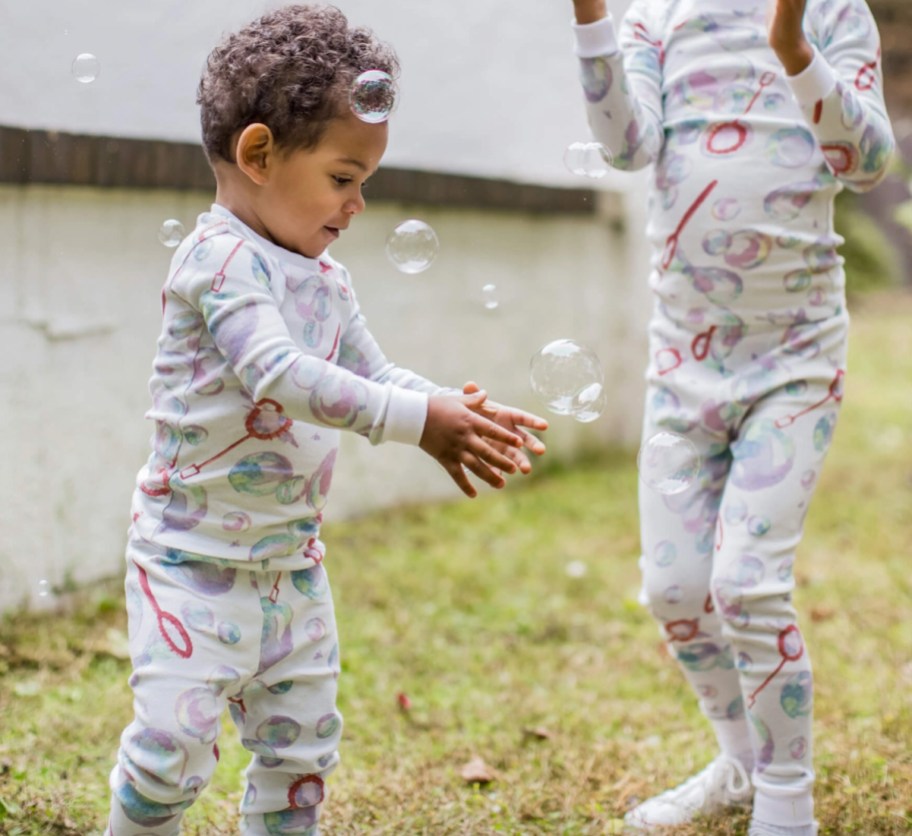 kids playing with bubbles wearing bubble pajamas
