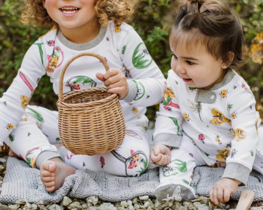 kids in bug pajamas holding basket