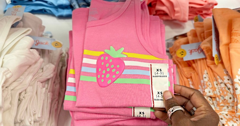 hand reaching for pink strawberry tank top
