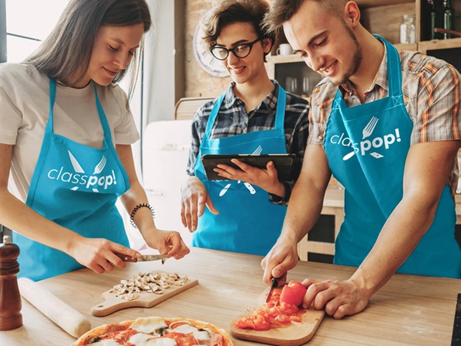 three people cooking while wearing blue classpop aprons