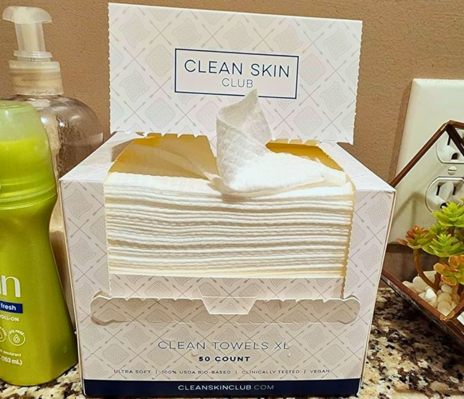 a box of clean skin club XL face towels on a bathroom counter