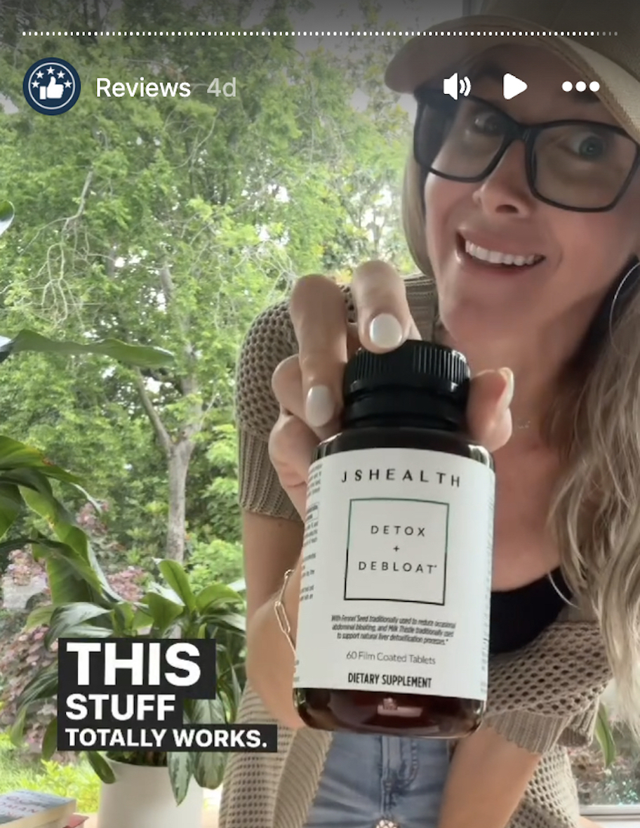 woman holding js health detox and debloat wellness pills