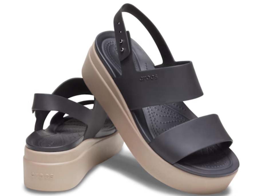 pair of brown and tan women's Crocs wedge sandals