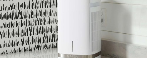 white and gray air purifier sitting on kitchen countertop